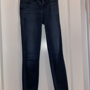 Paige mid rise skinny jeans with frayed bottom hem. Dark wash. 
Size: 23